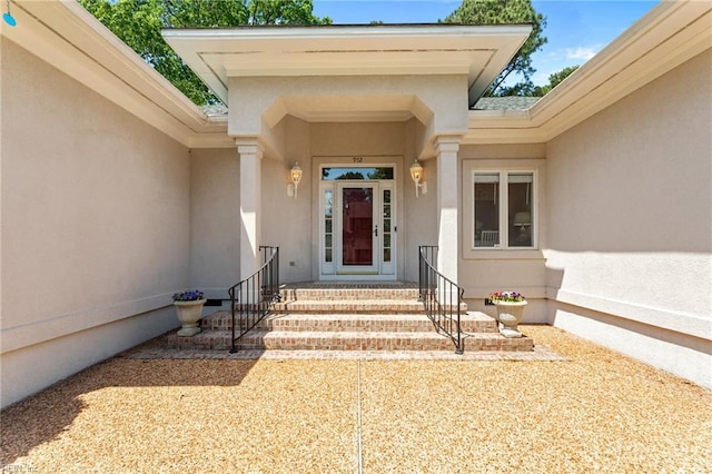 entrance to property with stucco siding