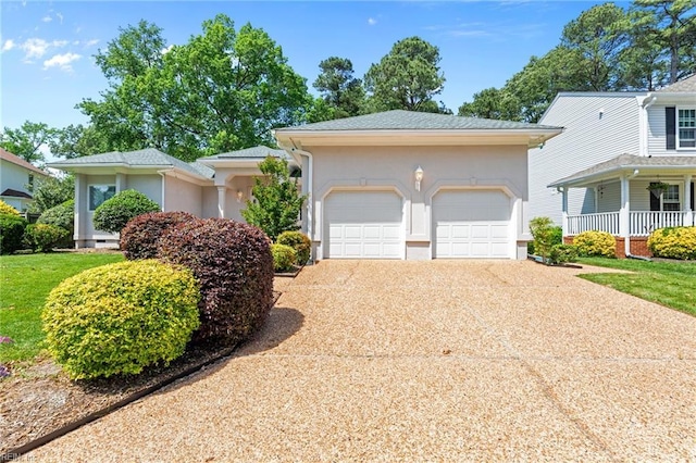 view of front of home featuring concrete driveway, an attached garage, and stucco siding