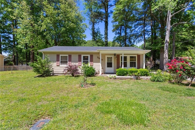 single story home featuring fence and a front lawn