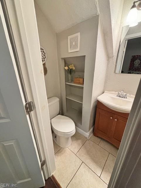 639 Mt Vernon Ave, Portsmouth, VA 23707 - bathroom with vanity, tile patterned floors, vaulted ceiling, and toilet