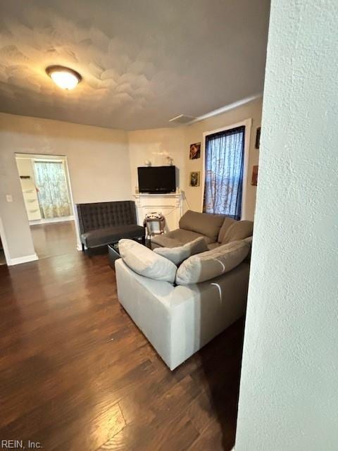 639 Mt Vernon Ave, Portsmouth, VA 23707 - living area with a textured wall, baseboards, plenty of natural light, and dark wood-type flooring