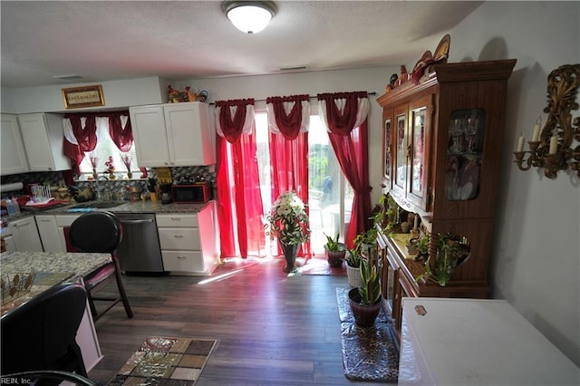 820 Pine Tree Ct, Newport News, VA 23608 - kitchen featuring dishwasher, white cabinets, a sink, dark wood finished floors, and backsplash