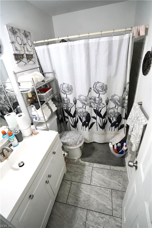 820 Pine Tree Ct, Newport News, VA 23608 - full bath with vanity, toilet, and a shower with curtain
