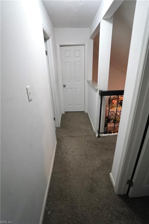 820 Pine Tree Ct, Newport News, VA 23608 - hallway with baseboards, a textured ceiling, and carpet