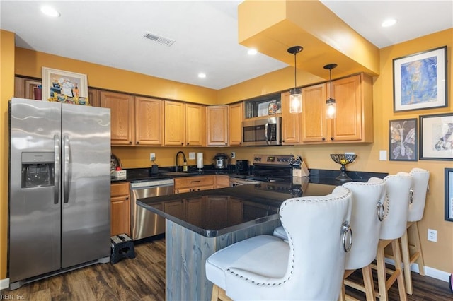 1132 Ocean Pebbles Way, Virginia Beach, VA 23451 - kitchen with dark wood-style flooring, dark countertops, a sink, stainless steel appliances, and visible vents