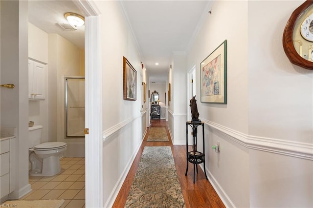 hall featuring ornamental molding, wood finished floors, and visible vents