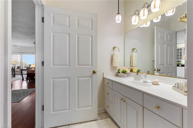 bathroom with vanity, baseboards, and wood finished floors