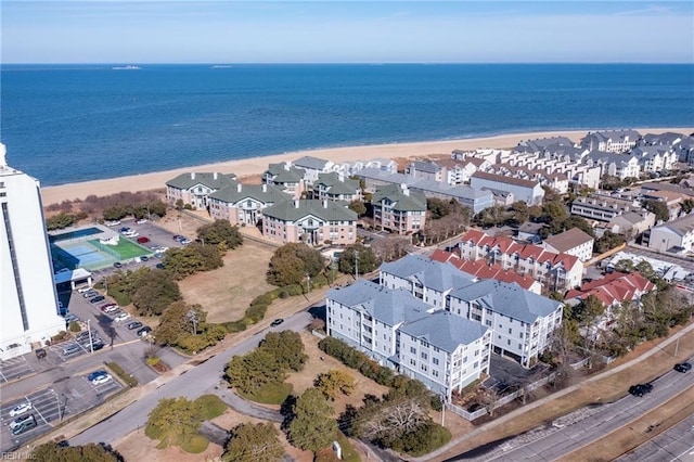 drone / aerial view featuring a water view and a beach view