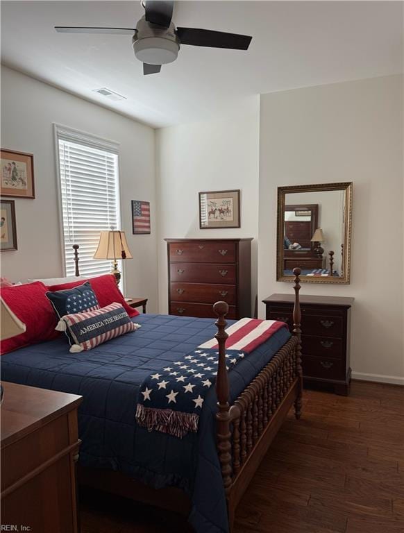 bedroom with baseboards, a ceiling fan, hardwood / wood-style floors, and visible vents