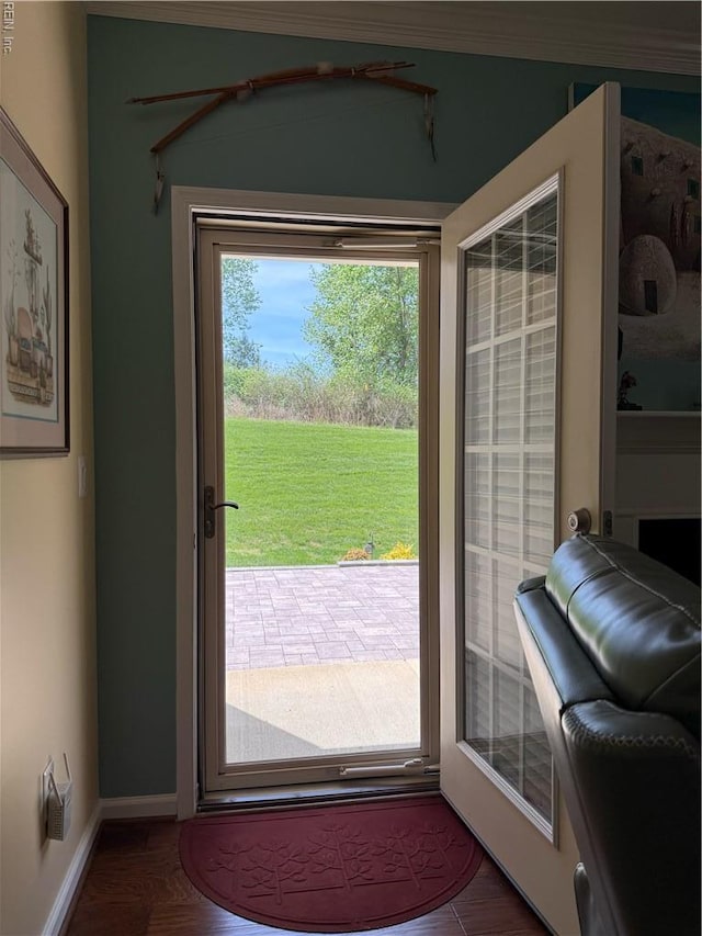 doorway to outside featuring baseboards