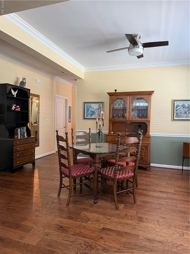 dining area with crown molding, a ceiling fan, baseboards, and dark wood-style floors
