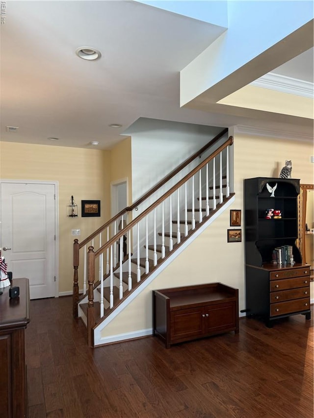 stairway with baseboards, recessed lighting, wood finished floors, and visible vents