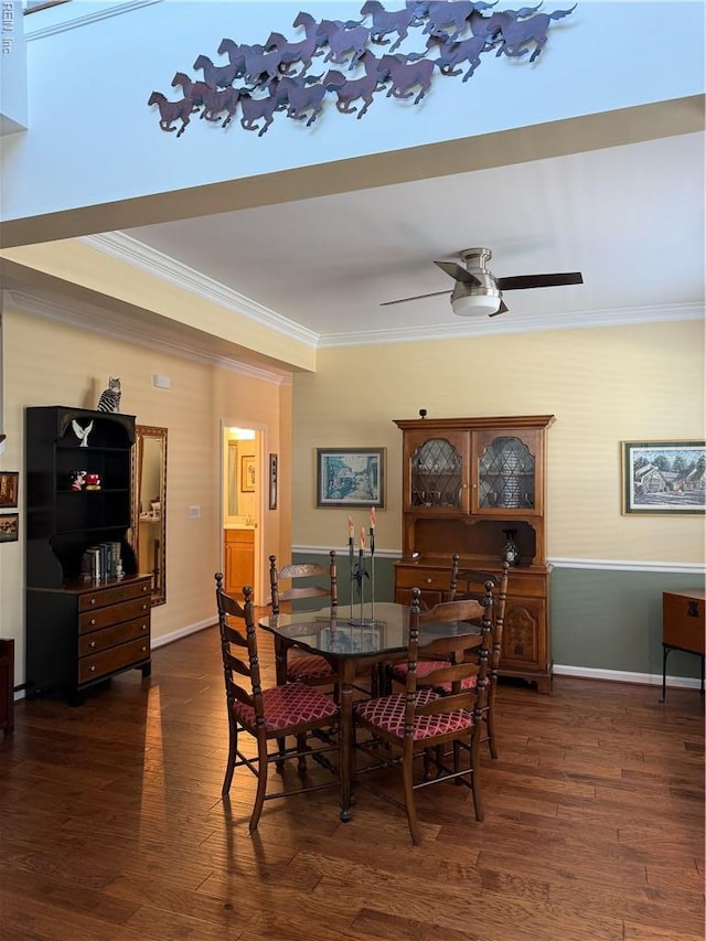 dining space with baseboards, ornamental molding, dark wood finished floors, and a ceiling fan