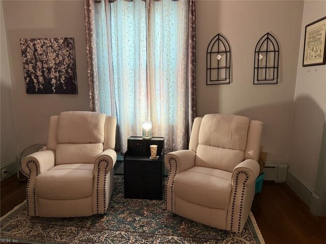 sitting room featuring baseboards and wood finished floors
