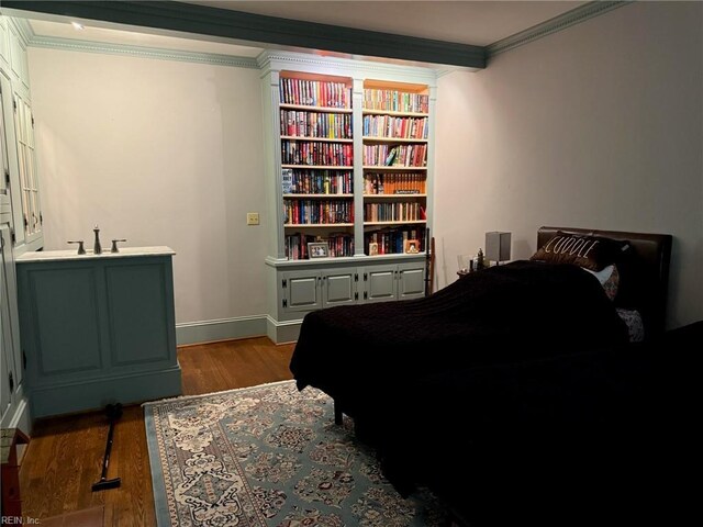 bedroom featuring baseboards, ornamental molding, and dark wood-type flooring
