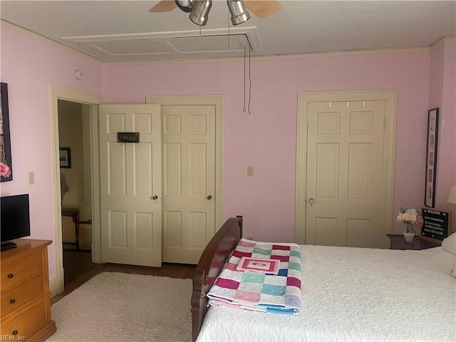 bedroom featuring a ceiling fan and attic access
