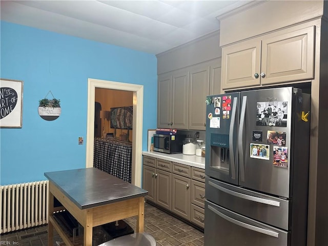 114 Thomas St, Smithfield, VA 23430 - kitchen featuring light countertops, radiator, stainless steel appliances, and brick patterned floor