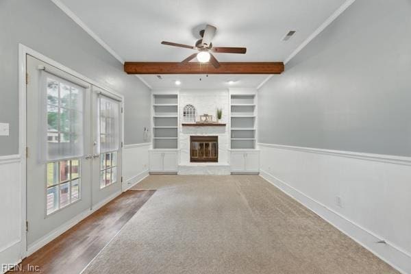 2 Sarfan Dr, Hampton, VA 23664 - unfurnished living room with french doors, a ceiling fan, beam ceiling, wainscoting, and built in shelves