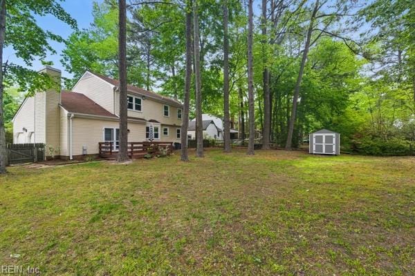 2 Sarfan Dr, Hampton, VA 23664 - view of yard with a deck, an outdoor structure, a storage shed, and fence
