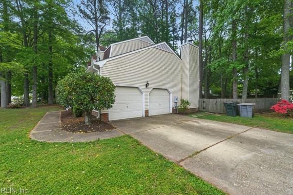 2 Sarfan Dr, Hampton, VA 23664 - view of property exterior featuring fence, an attached garage, concrete driveway, a chimney, and a lawn