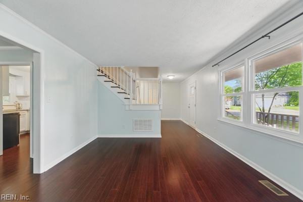 2 Sarfan Dr, Hampton, VA 23664 - unfurnished living room featuring visible vents, baseboards, stairway, and dark wood-style floors