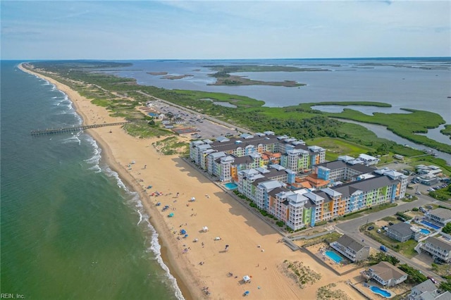 birds eye view of property featuring a beach view and a water view