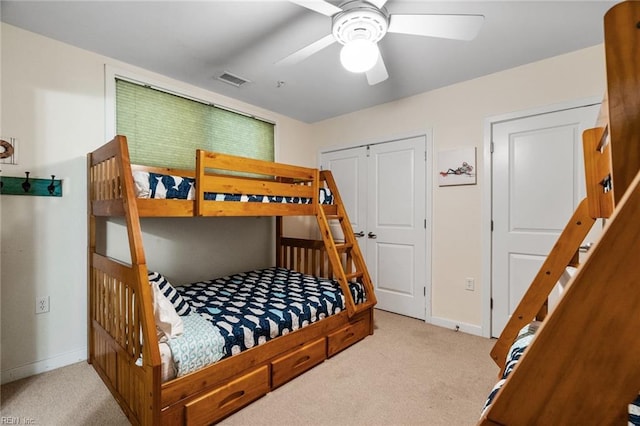 bedroom featuring baseboards, carpet flooring, a ceiling fan, and visible vents