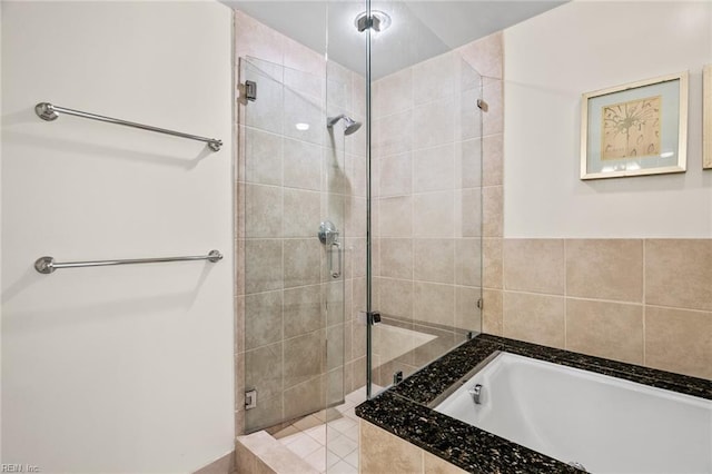 full bath with a bath and a stall shower