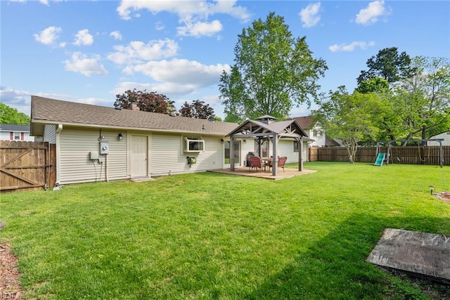rear view of house featuring a gazebo, a fenced backyard, a playground, a yard, and a patio