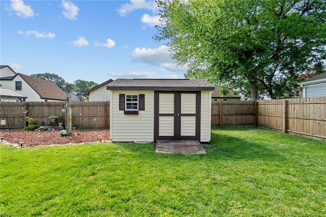 view of shed with a fenced backyard