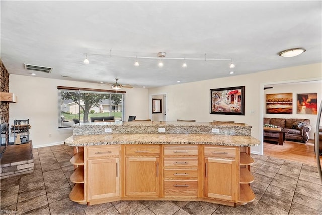 kitchen with track lighting, open shelves, visible vents, and light brown cabinets
