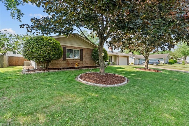 single story home featuring a garage, fence, a front lawn, and brick siding