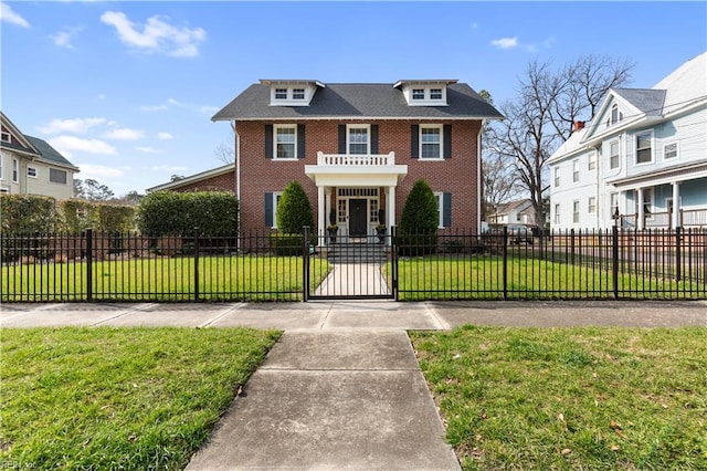 view of front of home featuring brick siding, a fenced front yard, a gate, and a front lawn