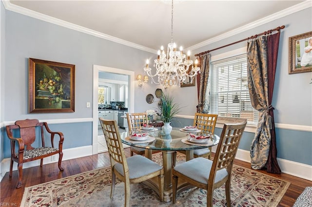 dining area with crown molding, baseboards, a chandelier, and hardwood / wood-style flooring
