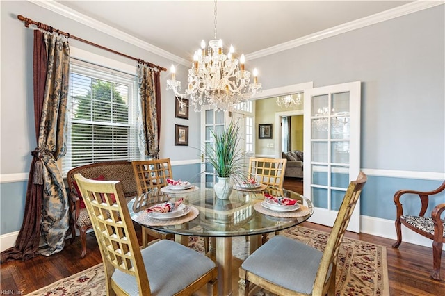 dining area with crown molding, baseboards, wood finished floors, and a chandelier