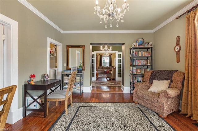 living area featuring crown molding, baseboards, wood finished floors, and a notable chandelier
