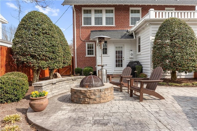 view of patio / terrace featuring fence and a fire pit