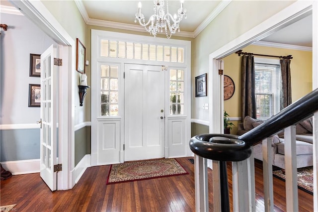 foyer with crown molding, baseboards, a chandelier, and dark wood-type flooring