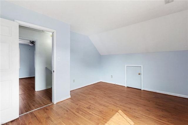 bonus room with vaulted ceiling, baseboards, a ceiling fan, and wood finished floors