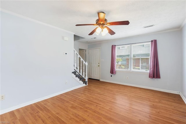 empty room with stairway, baseboards, and light wood-style floors