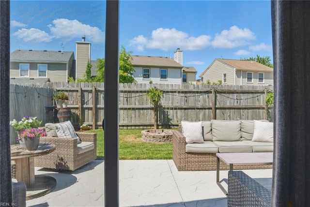view of patio / terrace with fence, an outdoor living space, and a residential view