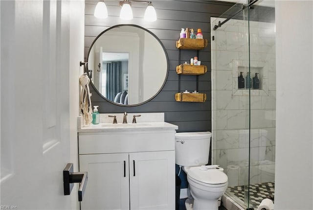 bathroom with vanity, toilet, and a shower stall