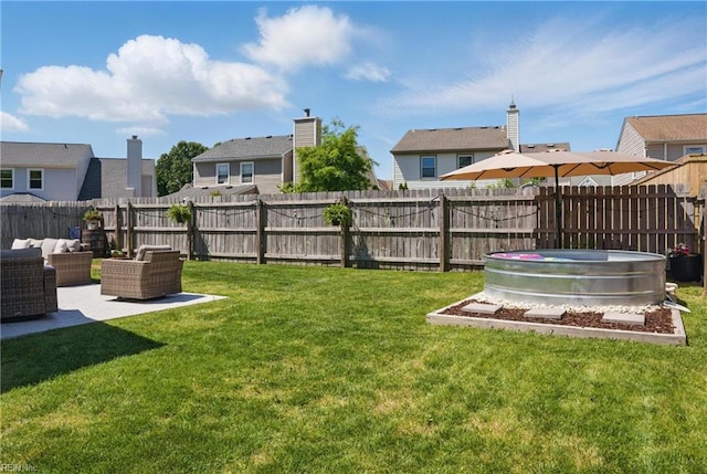 view of yard featuring a residential view, an outdoor hangout area, a fenced backyard, and a patio area