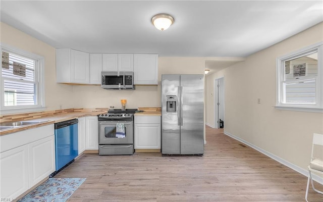 921 Quash St, Hampton, VA 23669 - kitchen with appliances with stainless steel finishes, white cabinets, and light wood finished floors