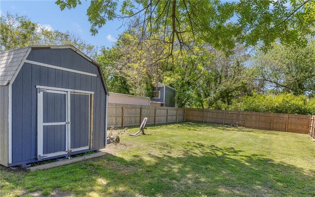 921 Quash St, Hampton, VA 23669 - view of yard featuring an outdoor structure, a shed, and a fenced backyard