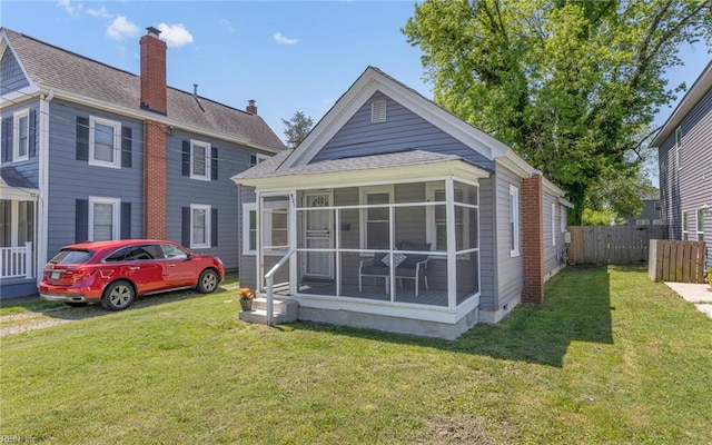 921 Quash St, Hampton, VA 23669 - rear view of house with a chimney, a lawn, a sunroom, fence, and a shingled roof