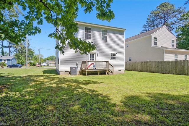 back of property with crawl space, a wooden deck, central AC unit, fence, and a yard
