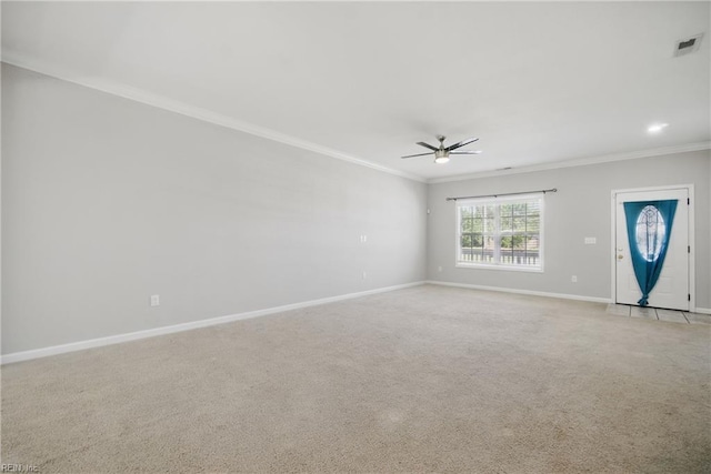 unfurnished living room featuring ceiling fan, light colored carpet, crown molding, visible vents, and baseboards