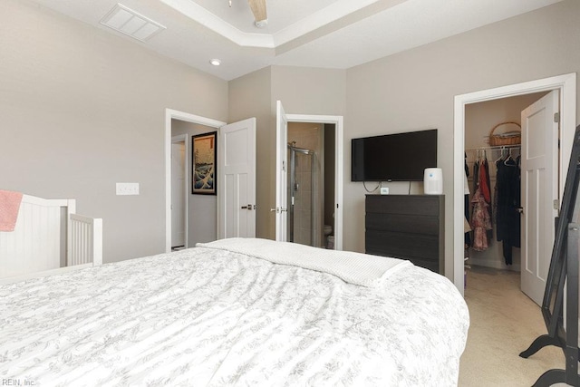 bedroom with visible vents, light carpet, a spacious closet, and a closet