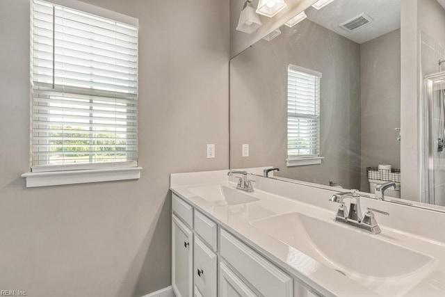 bathroom featuring visible vents, a healthy amount of sunlight, and a sink